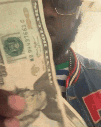 Man Holding Stack Of Money With Bill Saying NB943736610 GIF