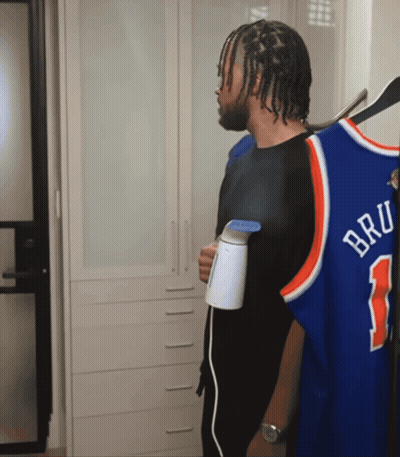 Man Holding Steamer Next To Bru Jersey GIF