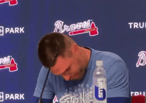 Man Holding Stuffed Animal At Microphone With Smart Water GIF