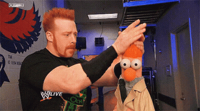 Man Holding Stuffed Animal In Front Of W Live Sign GIF