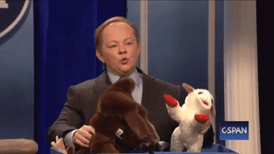 Man Holding Stuffed Animals In Front Of C-SPAN Sign GIF