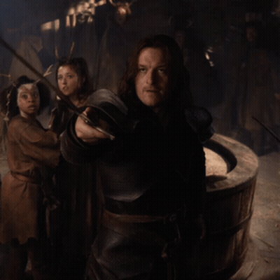 Man Holding Sword In Dark Room GIF