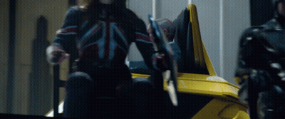 Man Holding Sword In Yellow Vehicle GIF