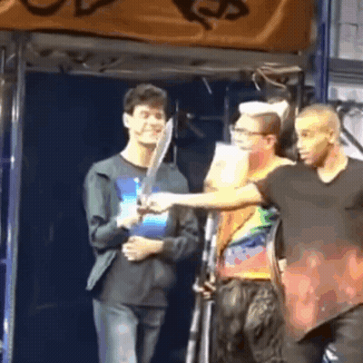 Man Holding Sword Next To Another GIF