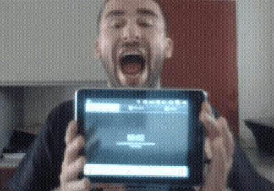 Man Holding Tablet With Mouth Open Showing 00:00 GIF