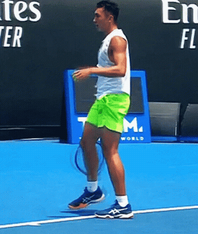 Man Holding Tennis Racket In Front Of Emirates Sign GIF