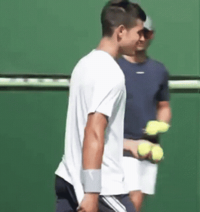 Man Holding Tennis Racket On Tennis Court GIF