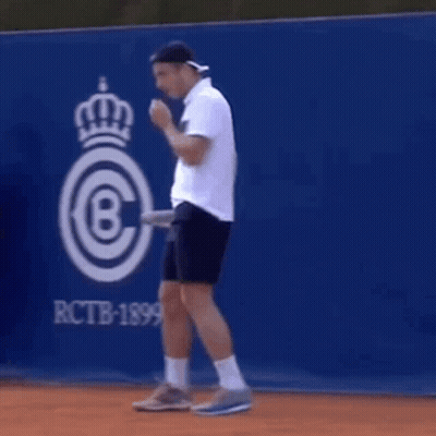 Man Holding Tennis Racket On Tennis Court GIF