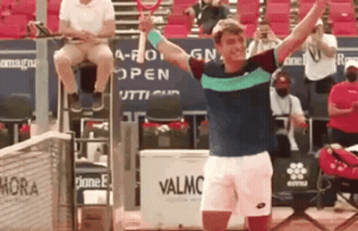 Man Holding Tennis Racquet And Man Sitting GIF