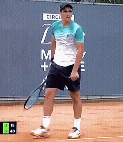 Man Holding Tennis Racquet In Front Of Circul Sign GIF