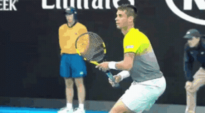 Man Holding Tennis Racquet In Front Of Emirates Sign GIF