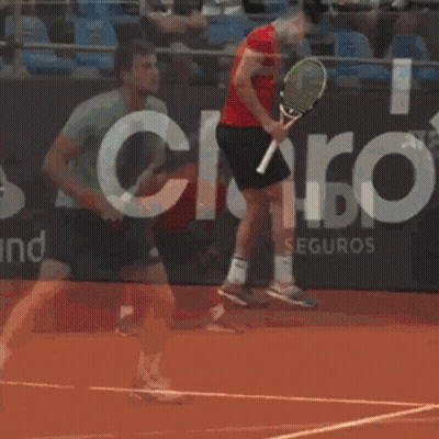 Man Holding Tennis Racquet In Front Of HDI Seguros Sign GIF