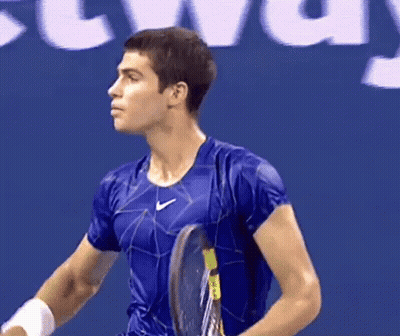 Man Holding Tennis Racquet In Front Of Localiza Sign GIF