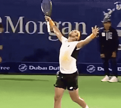 Man Holding Tennis Racquet In Front Of Morgan Sign GIF