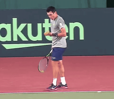 Man Holding Tennis Racquet In Front Of Rakuten Sign GIF