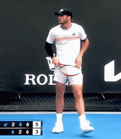 Man Holding Tennis Racquet In Front Of Rolex Sign GIF