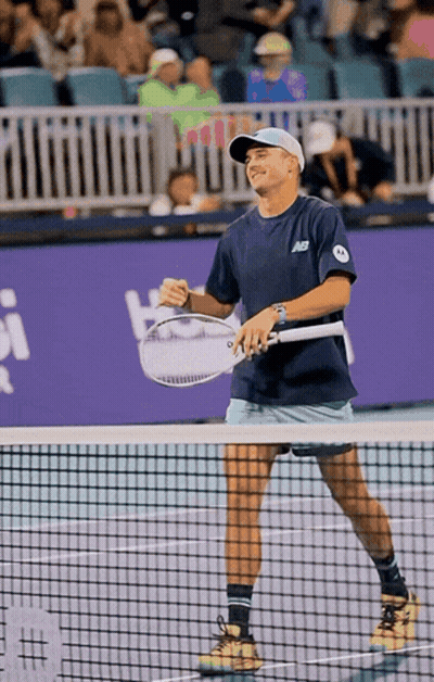 Man Holding Tennis Racquet In New Balance Shirt GIF