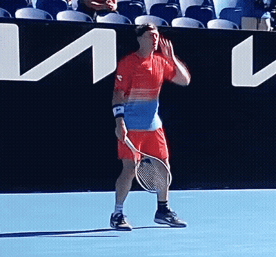 Man Holding Tennis Racquet On Blue Court GIF