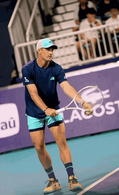 Man Holding Tennis Racquet On Court Saying New Balance GIF