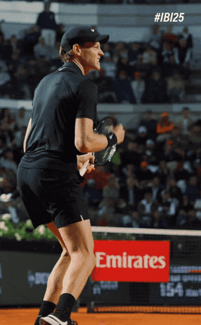 Man Holding Tennis Racquet On Court With Emirates Sign GIF