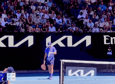 Man Holding Tennis Racquet On Court With Kia Sign GIF