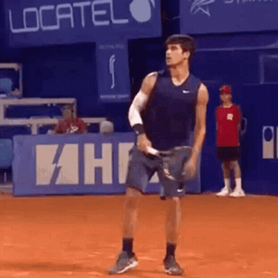 Man Holding Tennis Racquet On Court With Localiza Sign GIF