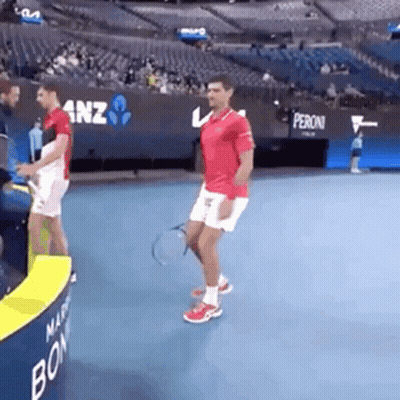 Man Holding Tennis Racquet On Tennis Court GIF