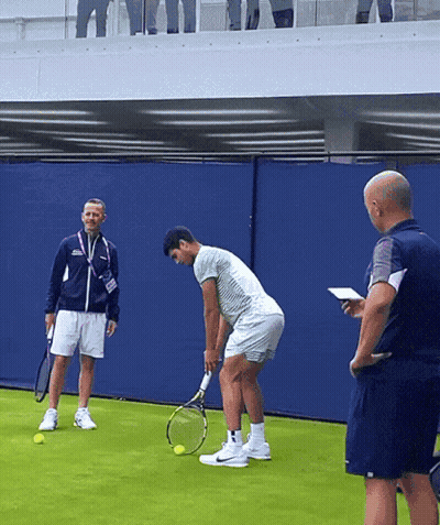 Man Holding Tennis Racquet With Another Man GIF