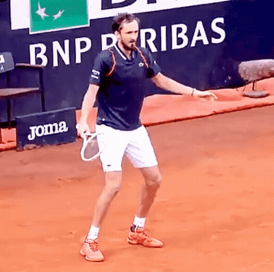 Man Holding Tennis Racquet With BNP Paribas Ad GIF