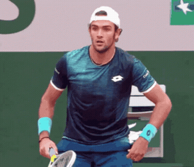 Man Holding Tennis Racquet with O