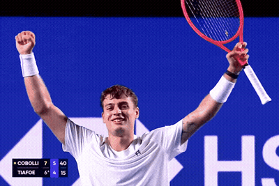 Man Holding Tennis Racquet With Scoreboard Cobolli Tiafoe GIF