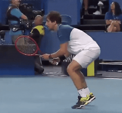 Man Holding Tennis Racquet Woman In Stands GIF