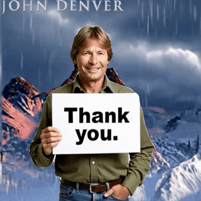 Man Holding Thank You Sign In Front Of John Denver Poster GIF