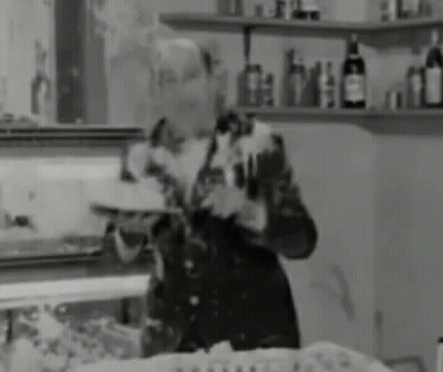 Man Holding Tray In Black And White GIF
