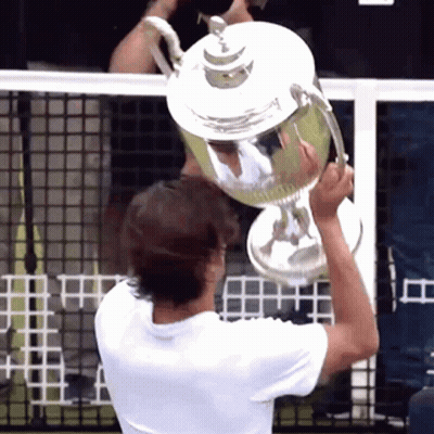 Man Holding Trophy Above Head GIF