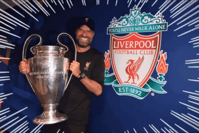 Man Holding Trophy And Liverpool Football Club Sign GIF