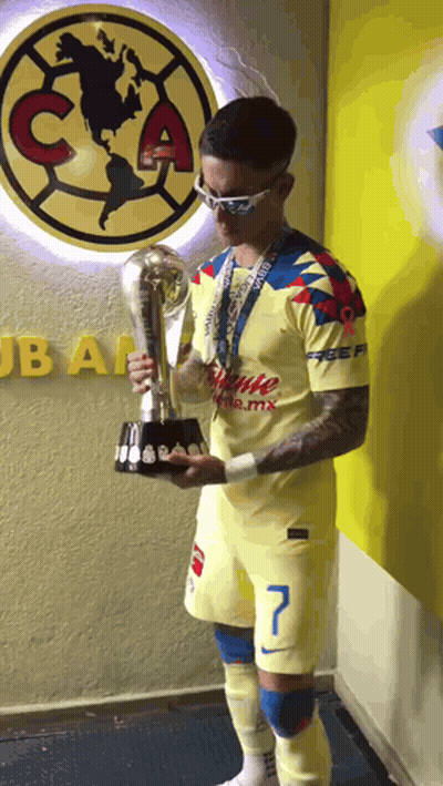Man Holding Trophy In Front Of Club America Wall GIF