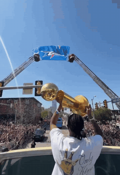 Man Holding Trophy In Front Of Crowd GIF