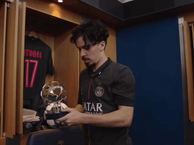 Man Holding Trophy In Locker Room With Number 17 Shirt GIF