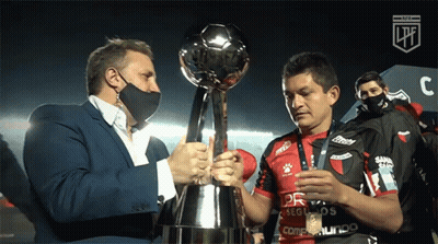 Man Holding Trophy Next To Jersey GIF