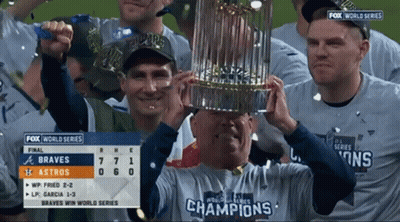 Man Holding Trophy Wearing Champions Shirt GIF