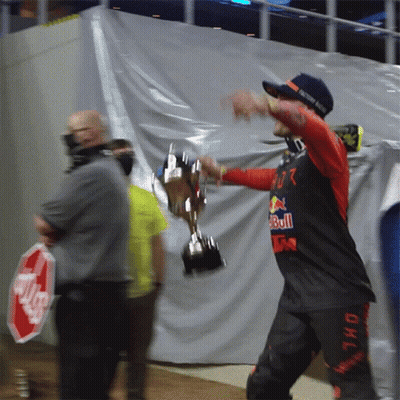 Man Holding Trophy With Red Bull Shirt GIF