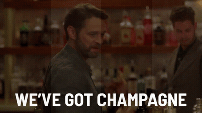 Man Holding Two Bottles Of Champagne Saying We've Got Champagne GIF