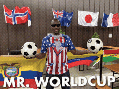 Man Holding Two Soccer Balls With Mr. World Cup Flags GIF