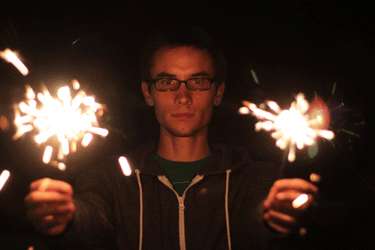 Man Holding Two Sparklers GIF