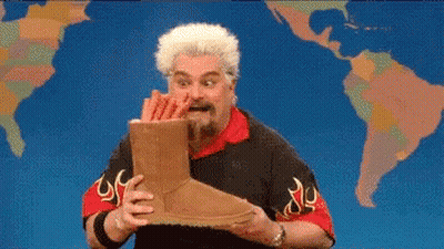 Man Holding Ugg Boots In Front Of World Map GIF