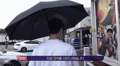 Man Holding Umbrella In Front Of Rec Camera GIF