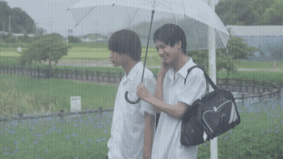 Man Holding Umbrella Next To Man With Bag GIF