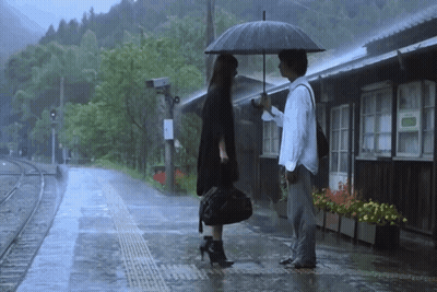 Man Holding Umbrella Next To Woman In Rain GIF