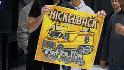 Man Holding Up Nickelback Poster GIF